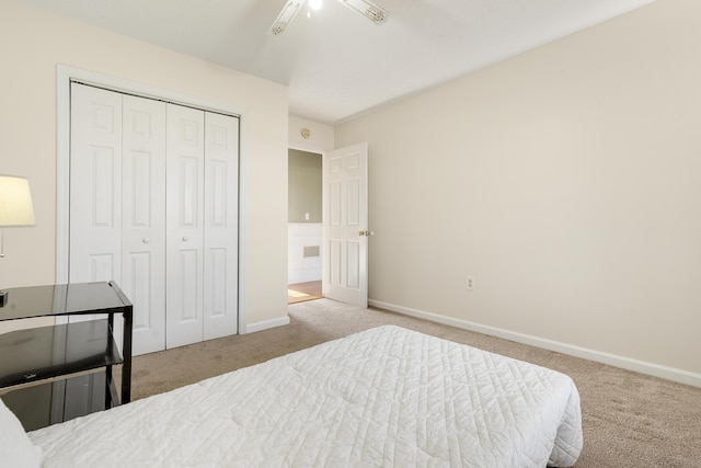 carpeted bedroom with a closet and ceiling fan