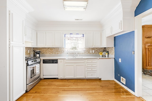 kitchen featuring dishwasher, white cabinetry, stainless steel range with gas cooktop, and sink