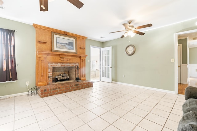 unfurnished living room featuring ceiling fan, light tile patterned floors, and a brick fireplace