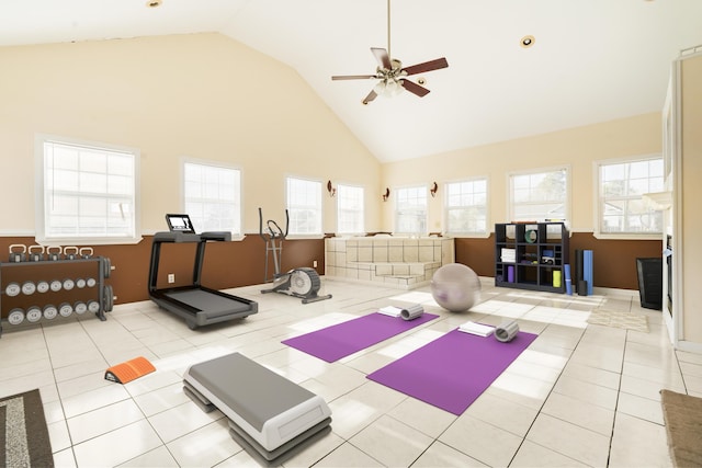 exercise room with light tile patterned floors, high vaulted ceiling, and ceiling fan