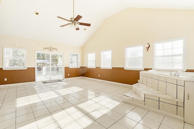 unfurnished living room featuring light tile patterned floors, high vaulted ceiling, and ceiling fan