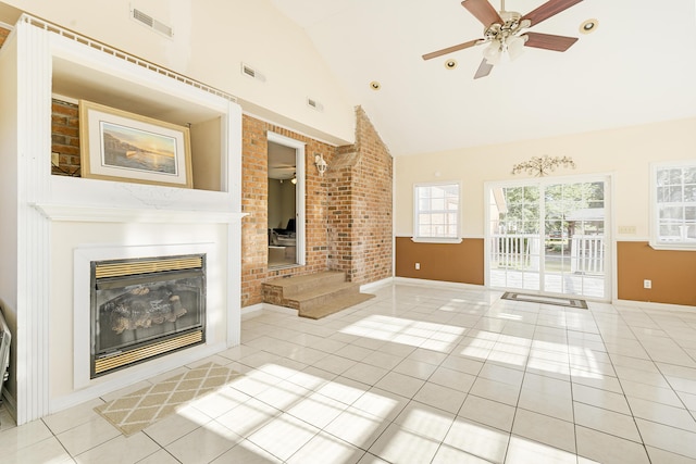 unfurnished living room with ceiling fan, light tile patterned floors, and lofted ceiling