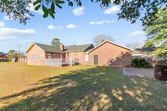 back of property featuring a lawn