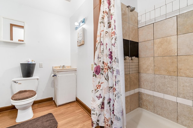 bathroom featuring hardwood / wood-style flooring, vanity, a shower with shower curtain, and toilet