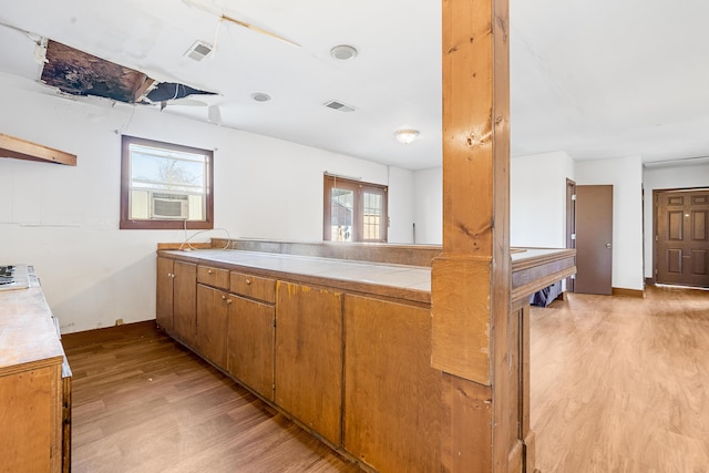 kitchen featuring plenty of natural light and light hardwood / wood-style floors