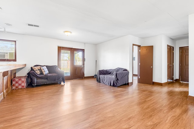 living room with cooling unit and light wood-type flooring