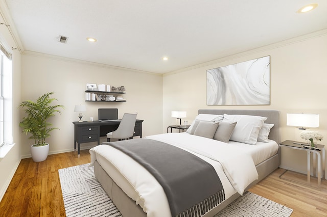 bedroom featuring light hardwood / wood-style floors and crown molding