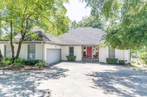 409 Santee Dr, Santee, SC 29142 - ranch-style home with an attached garage, driveway, and stucco siding