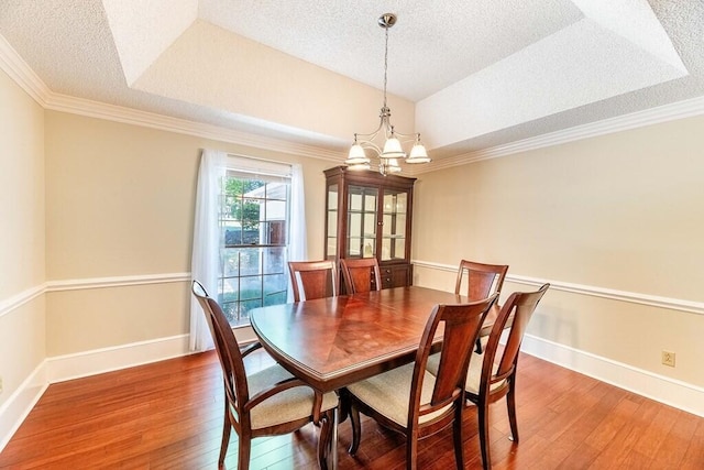 409 Santee Dr, Santee, SC 29142 - dining space featuring a chandelier, hardwood / wood-style floors, a textured ceiling, ornamental molding, and baseboards