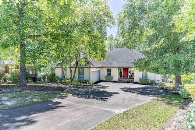 409 Santee Dr, Santee, SC 29142 - view of front of house with a garage, stucco siding, and driveway