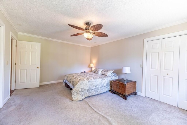 409 Santee Dr, Santee, SC 29142 - bedroom featuring carpet flooring, crown molding, a closet, baseboards, and a textured ceiling