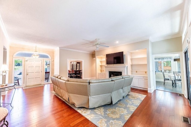 409 Santee Dr, Santee, SC 29142 - living area with crown molding, a ceiling fan, a fireplace, wood-type flooring, and baseboards