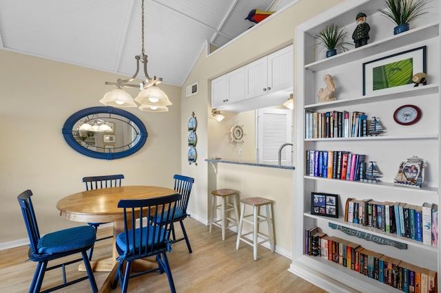 1376 Pelican Watch Villas, Seabrook Island, SC 29455 - dining space with a chandelier, light wood finished floors, vaulted ceiling, and baseboards