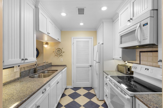 1376 Pelican Watch Villas, Seabrook Island, SC 29455 - kitchen with white appliances, a sink, light flooring, white cabinetry, and recessed lighting