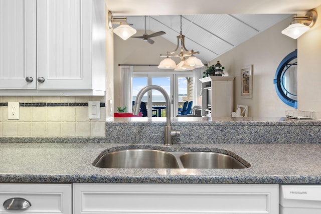 1376 Pelican Watch Villas, Seabrook Island, SC 29455 - kitchen with a sink, lofted ceiling, decorative backsplash, white cabinetry, and dishwasher