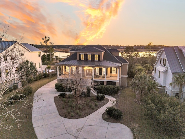 view of front facade with a water view and a porch