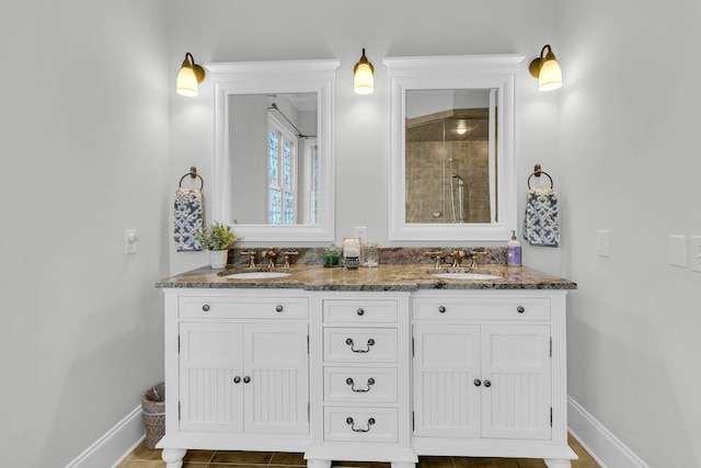 bathroom with a tile shower and vanity