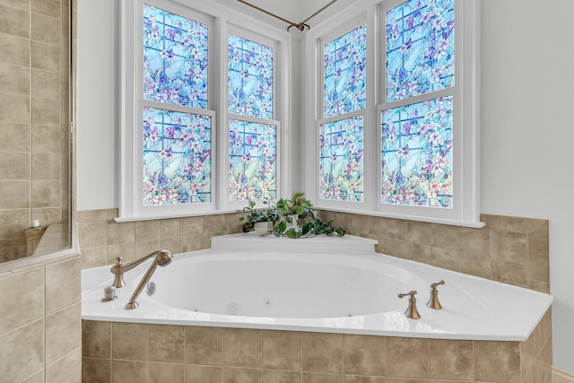 bathroom with a relaxing tiled tub