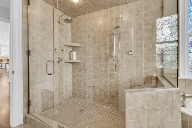 bathroom featuring a shower with shower door