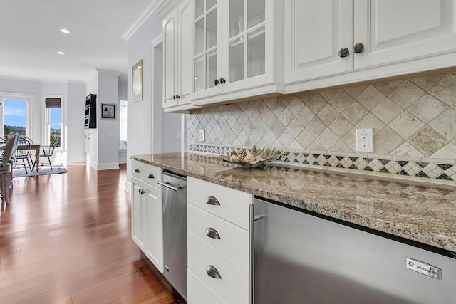 kitchen with white cabinetry, light stone countertops, dark hardwood / wood-style floors, and ornamental molding