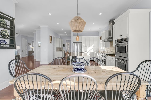 dining room with dark hardwood / wood-style floors and ornamental molding