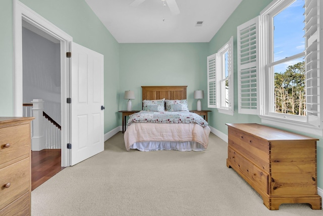 carpeted bedroom with ceiling fan and lofted ceiling