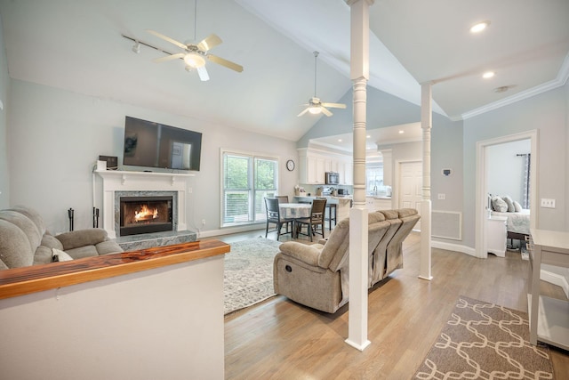 2177 Gulf Dr, Mount Pleasant, SC 29464 - living area with a ceiling fan, a fireplace, ornate columns, light wood finished floors, and ornamental molding