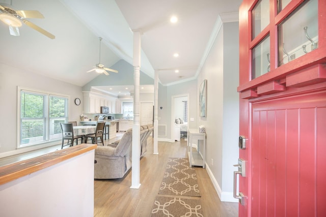 2177 Gulf Dr, Mount Pleasant, SC 29464 - entryway featuring crown molding, ceiling fan, light wood-style floors, healthy amount of natural light, and decorative columns