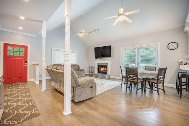 2177 Gulf Dr, Mount Pleasant, SC 29464 - living room featuring a ceiling fan, baseboards, a lit fireplace, decorative columns, and high vaulted ceiling