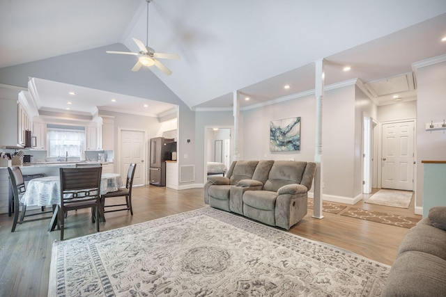 2177 Gulf Dr, Mount Pleasant, SC 29464 - living room featuring a ceiling fan, crown molding, baseboards, light wood-style flooring, and high vaulted ceiling