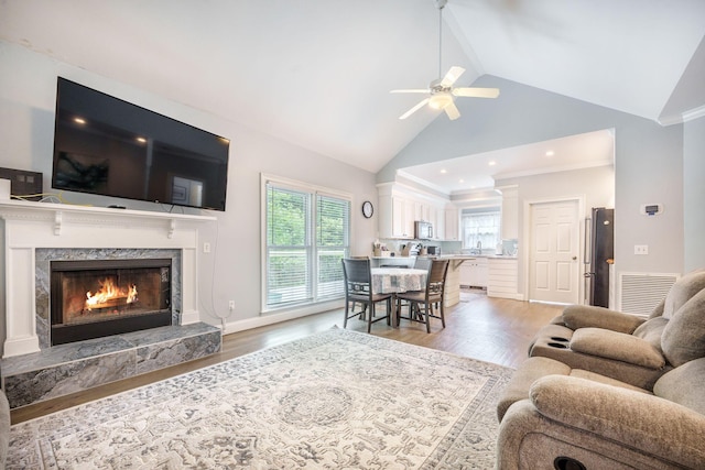 2177 Gulf Dr, Mount Pleasant, SC 29464 - living area with a ceiling fan, a high end fireplace, high vaulted ceiling, and light wood-type flooring