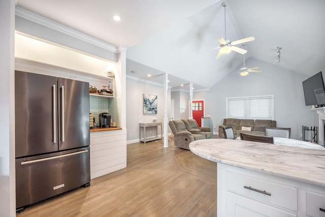 2177 Gulf Dr, Mount Pleasant, SC 29464 - kitchen with freestanding refrigerator, ornate columns, a ceiling fan, white cabinets, and lofted ceiling