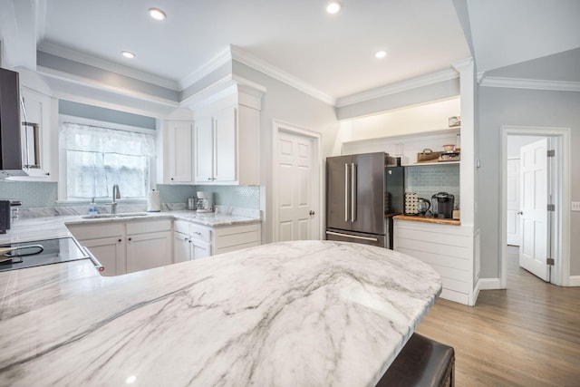 2177 Gulf Dr, Mount Pleasant, SC 29464 - kitchen featuring high end refrigerator, a sink, light stone countertops, decorative backsplash, and ornamental molding