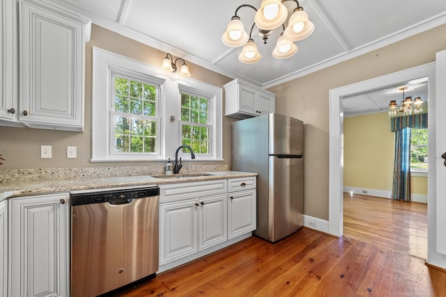 kitchen with white cabinets, sink, light hardwood / wood-style flooring, stainless steel appliances, and light stone countertops