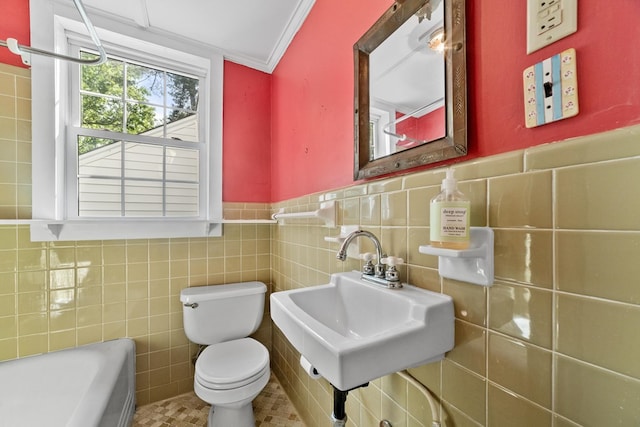 bathroom featuring ornamental molding, sink, tile walls, and toilet