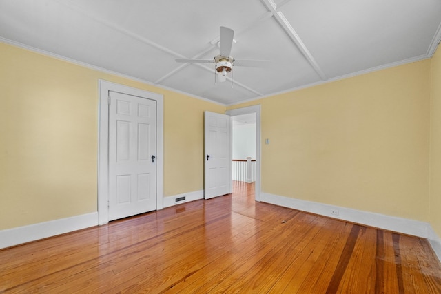 unfurnished bedroom with crown molding, hardwood / wood-style flooring, and ceiling fan