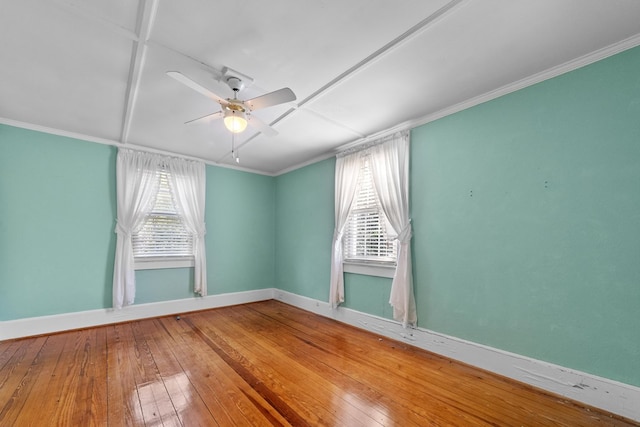 empty room featuring ornamental molding, ceiling fan, and wood-type flooring