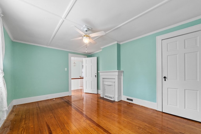 unfurnished bedroom with wood-type flooring, crown molding, and ceiling fan