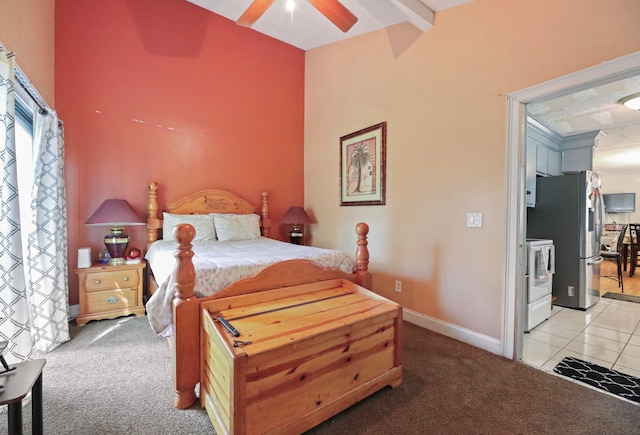 bedroom with ceiling fan, light colored carpet, stainless steel refrigerator, and vaulted ceiling with beams