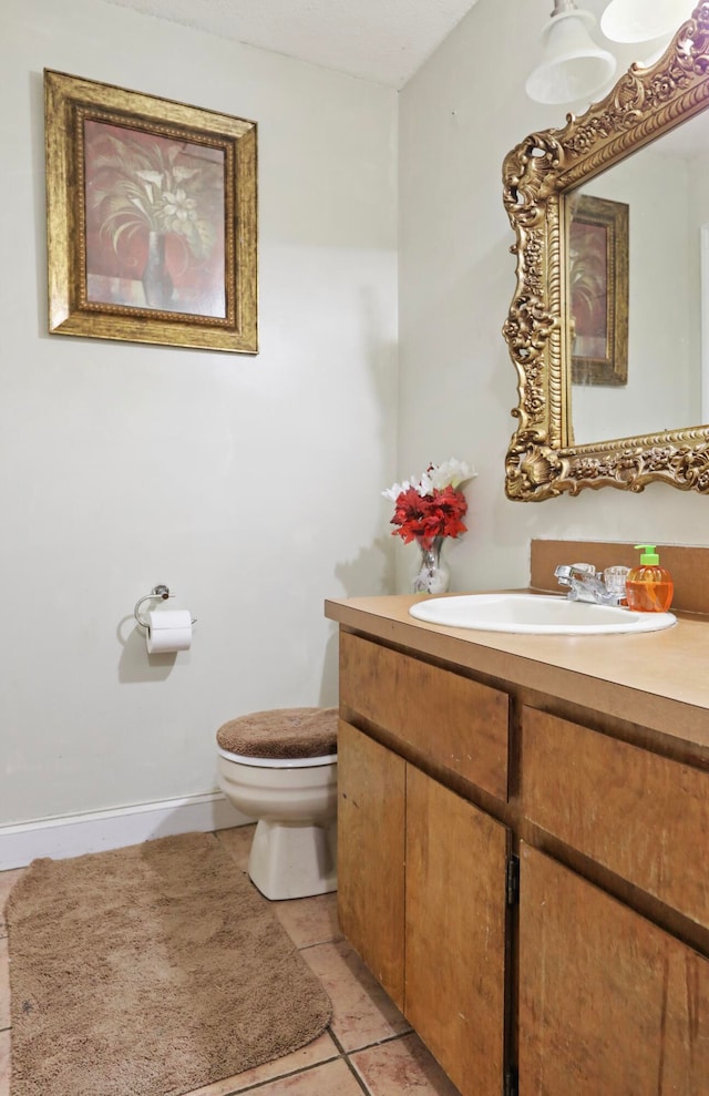 bathroom with vanity, toilet, and tile patterned floors