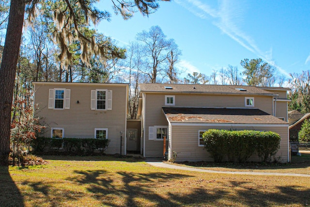 back of property featuring a yard