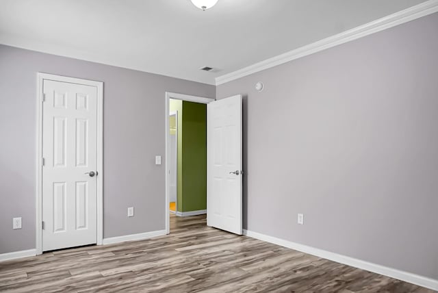3632 Locklear Ln, Mount Pleasant, SC 29466 - unfurnished bedroom featuring wood finished floors, baseboards, and crown molding