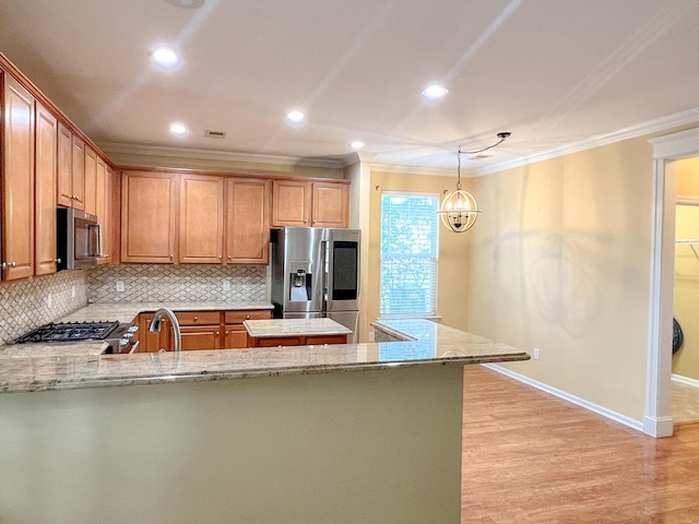3632 Locklear Ln, Mount Pleasant, SC 29466 - kitchen with appliances with stainless steel finishes, ornamental molding, a peninsula, backsplash, and light wood finished floors
