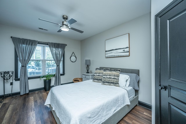 bedroom with ceiling fan and dark hardwood / wood-style floors