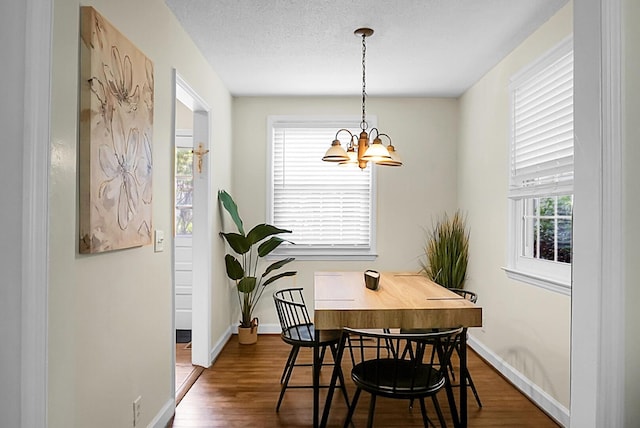 4810 Parkside Dr, North Charleston, SC 29405 - dining space with wood finished floors, a chandelier, and baseboards