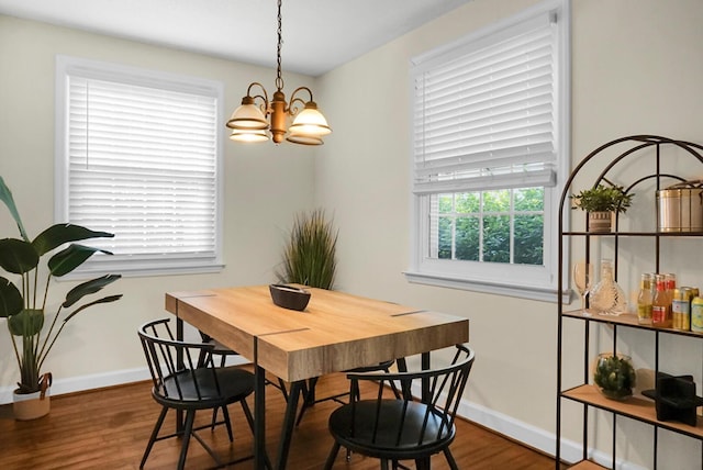 4810 Parkside Dr, North Charleston, SC 29405 - dining area featuring a chandelier, wood finished floors, and baseboards