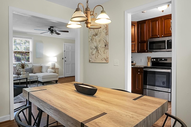 4810 Parkside Dr, North Charleston, SC 29405 - dining room featuring a ceiling fan, a chandelier, and dark wood-style floors