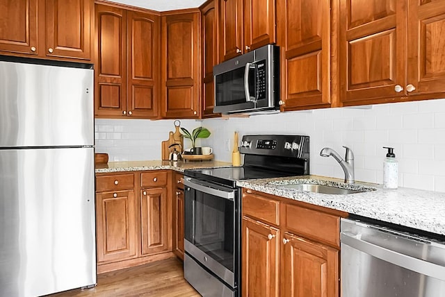 4810 Parkside Dr, North Charleston, SC 29405 - kitchen featuring stainless steel appliances, a sink, tasteful backsplash, and light stone countertops