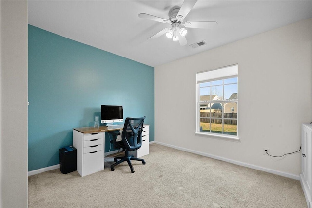 office featuring light carpet, visible vents, and baseboards