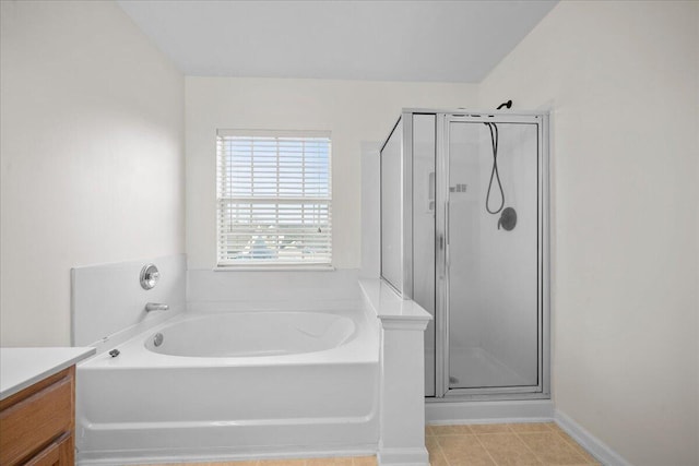 full bath with a garden tub, a shower stall, and vanity